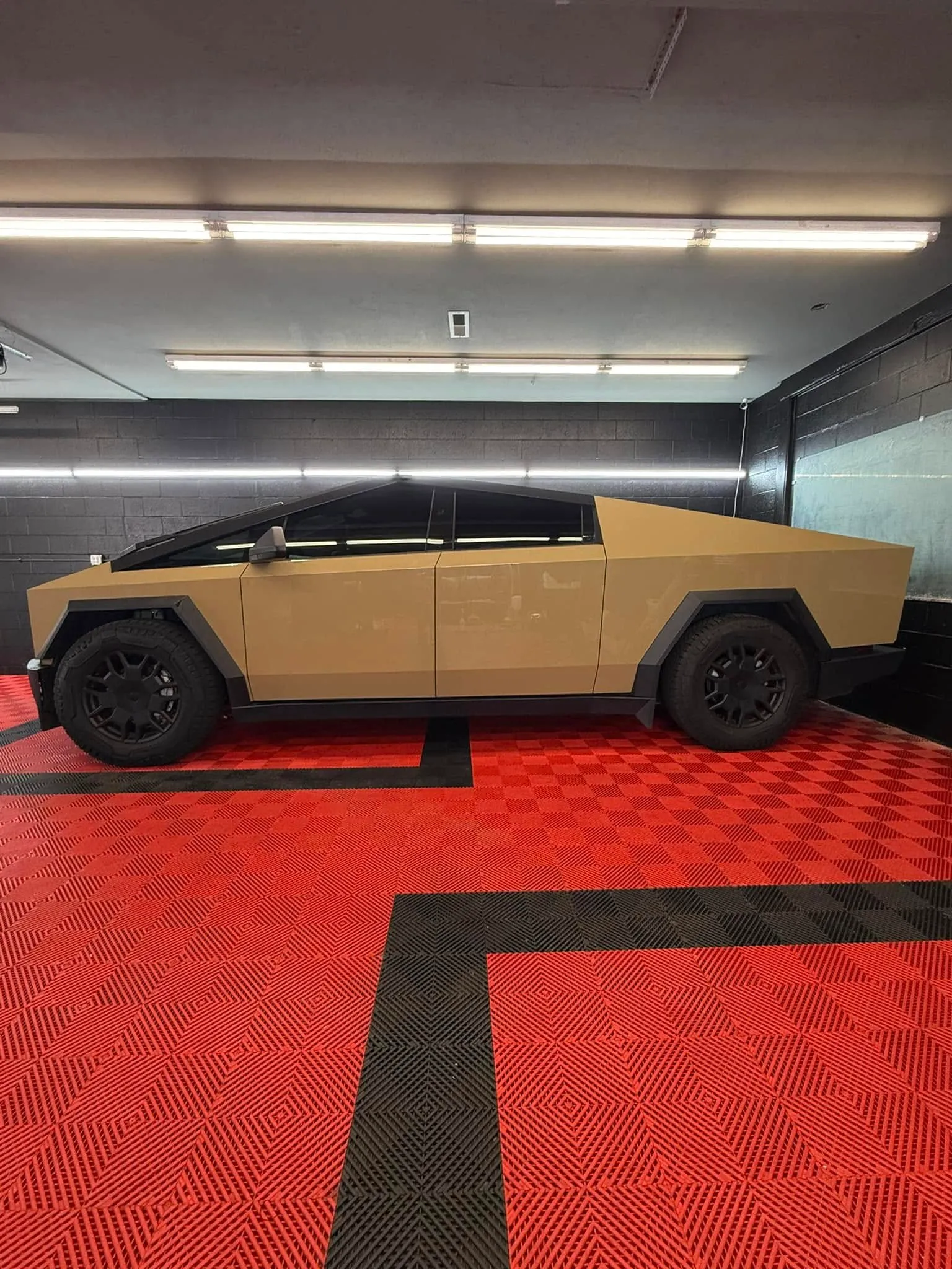 Tan-wrapped Tesla Cybertruck inside the Redline Tinting install bay ready for window tint installation