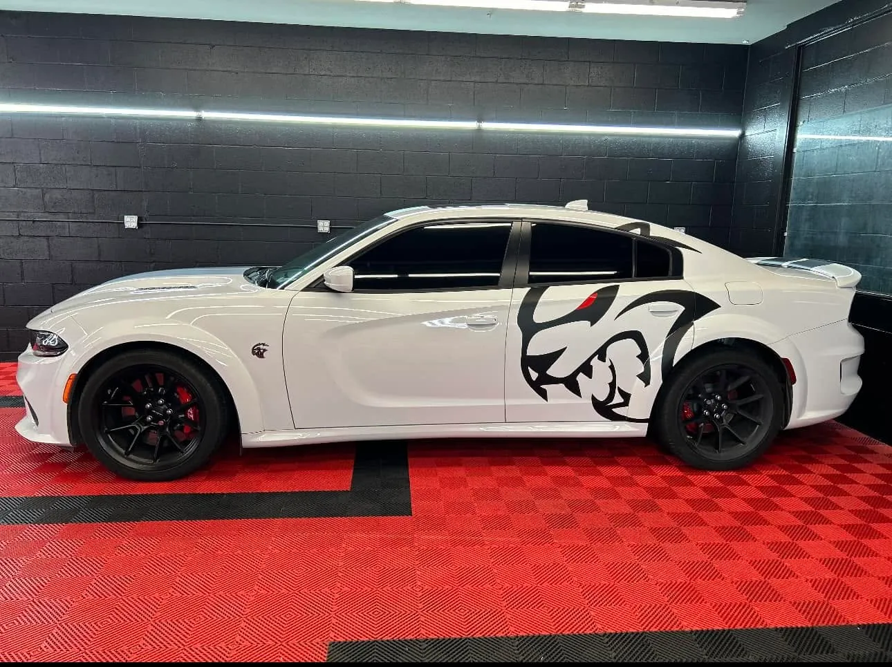 White Dodge Charger Hellcat SRT Redeye with the Hellcat mascot decal and freshly installed dark window tint