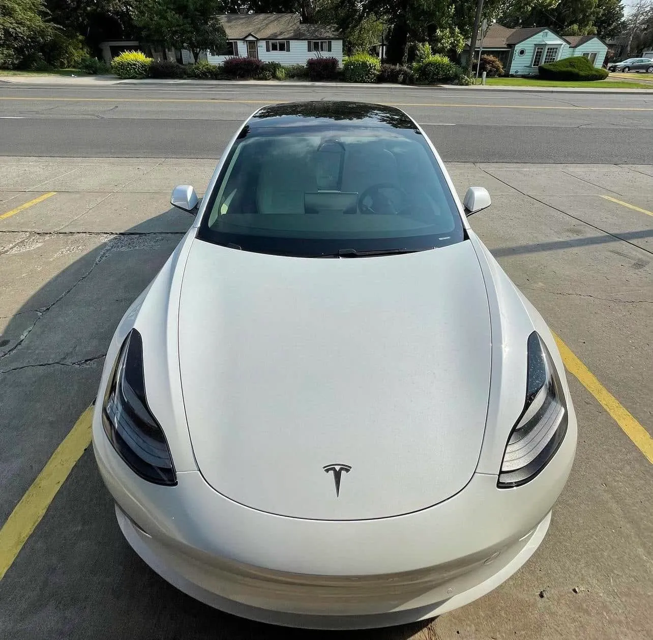 White Tesla Model 3 with ceramic windshield tint and front-window film, front three-quarter view